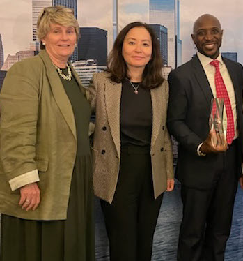 Left to right: Cathy Callahan (Northeast Region Executive, BAC) and Ozoda Jovliyeva (Simeon Iheagwam’s Relationship Manager, BAC), stand beside Simeon Iheagwam (Founder and Managing Partner, NOEMIS) as he holds the 2024 Dealmakers of the Year Award for Social Impact.