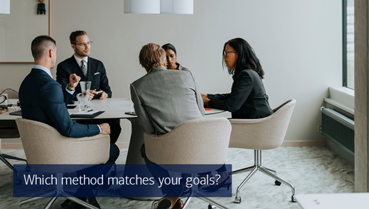A group of people meet at a conference table. Text reads which method matches your goals?